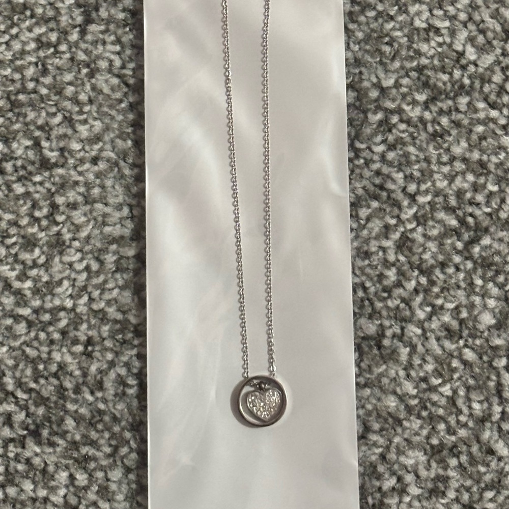 Silver necklace with heart shaped charm with diamond embellishments